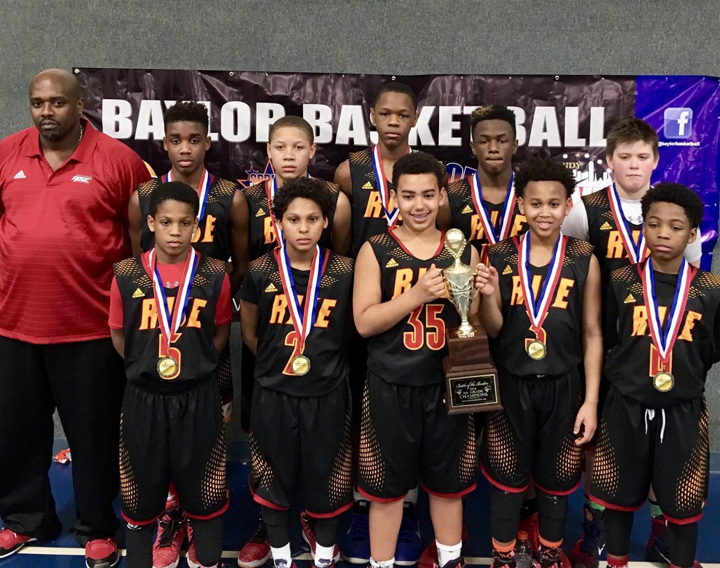 A We Don't Miss youth team posing with medals and a championship trophy